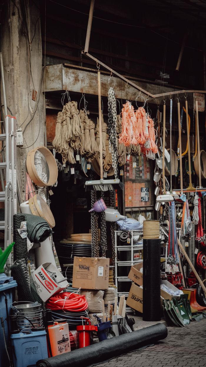 Rustic workshop filled with various tools, materials, and industrial supplies.