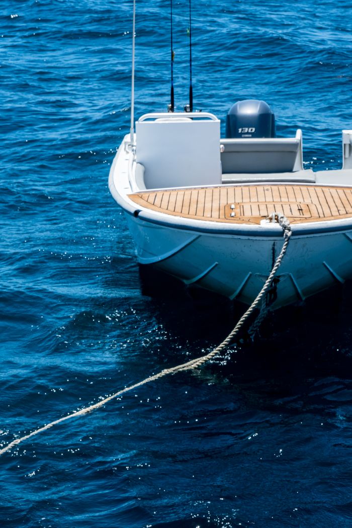 A high-end motorboat docked on the ocean with a visible rope, perfect for leisure and travel imagery.